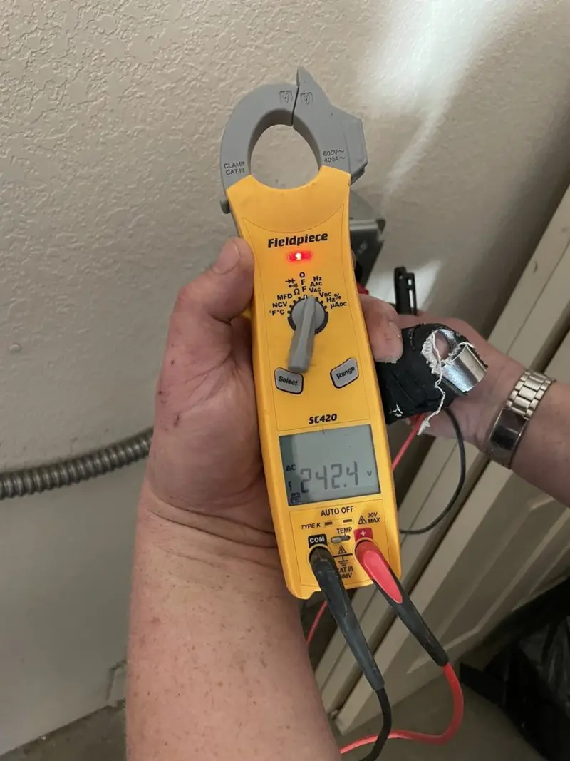 Voltage testing with clamp meter during Outlet Installation in Tisbury
